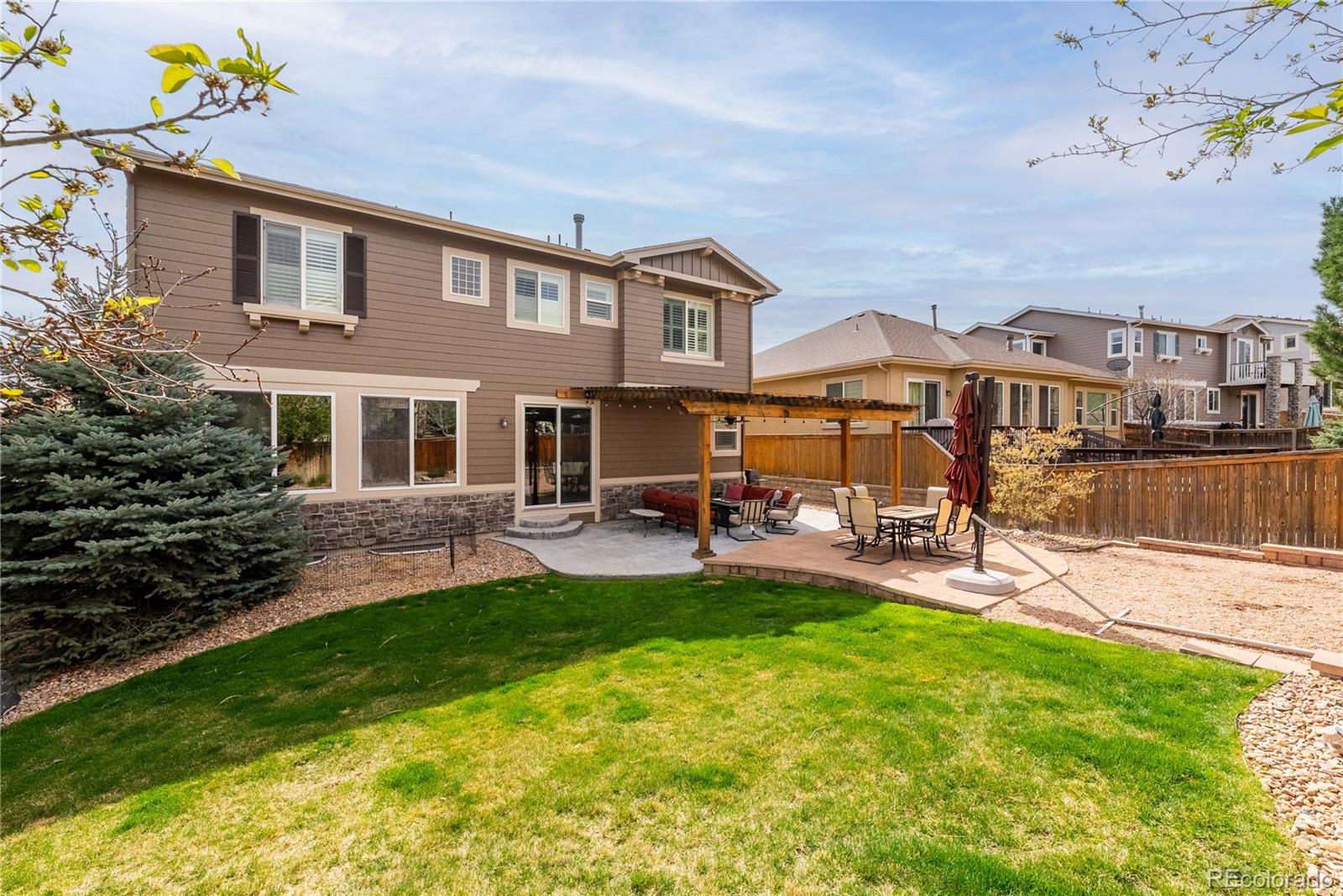 10960 Glengate Circle Highlands Ranch, CO 80130 - Photo 40 of 50 a view of a house with a yard and sitting area