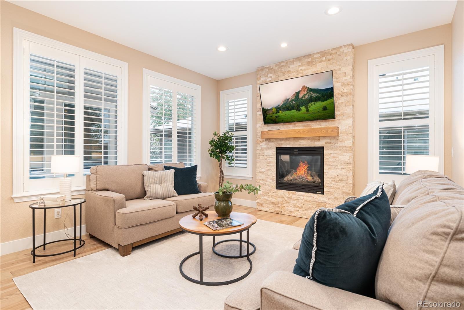 10960 Glengate Circle Highlands Ranch, CO 80130 - Photo 8 of 50 a living room with furniture large window and a fireplace