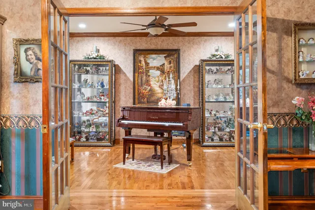 a living room with furniture a flat screen tv and a book shelf