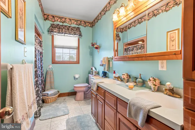 a view of a kitchen with kitchen island stainless steel appliances refrigerator stove microwave and stove