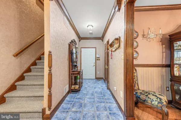 a dining room with furniture a chandelier and wooden floor