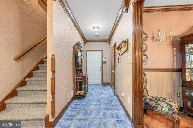 a dining room with furniture a chandelier and wooden floor