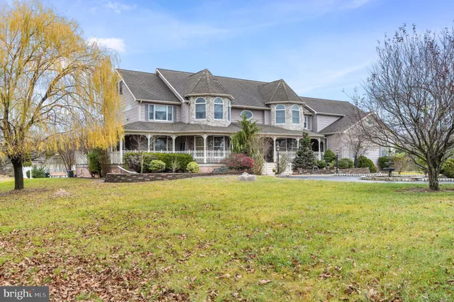 a front view of residential houses with yard and green space