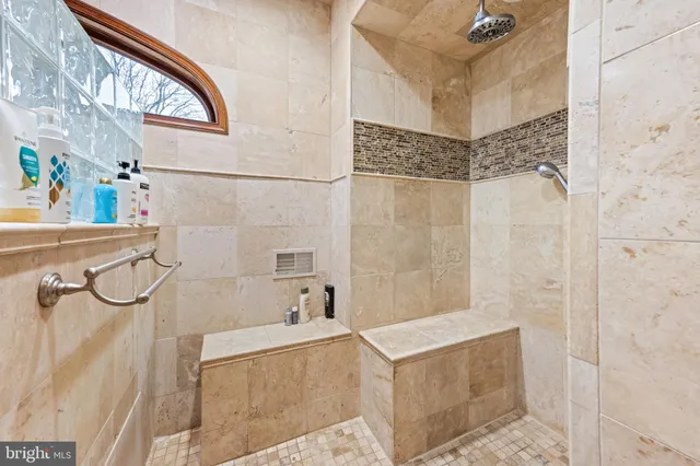 a bedroom with a bed and a large window with the outer view