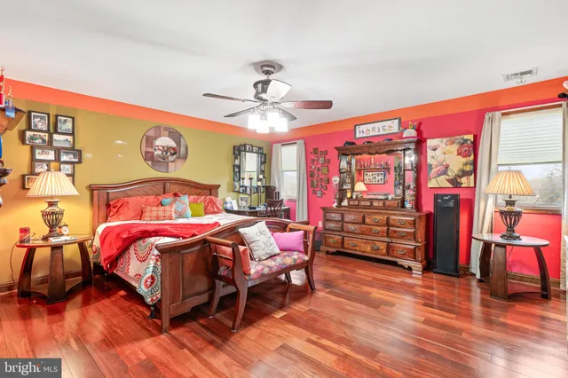 a room with stainless steel appliances kitchen island granite countertop a table and chairs in it
