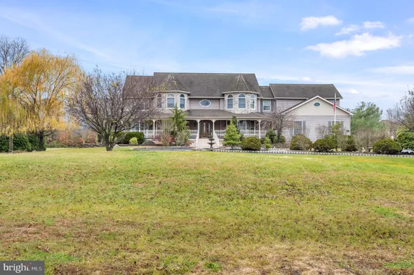 a dining room with furniture window and wooden floor