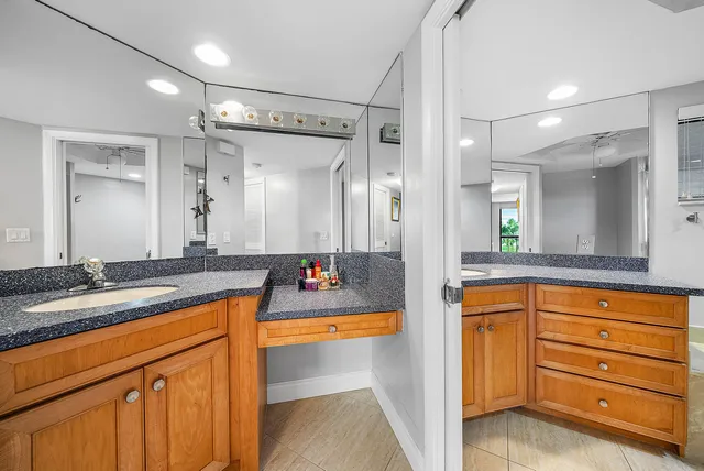 a bathroom with a granite countertop sink mirror and double