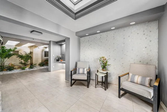 a living room with furniture and a potted plant
