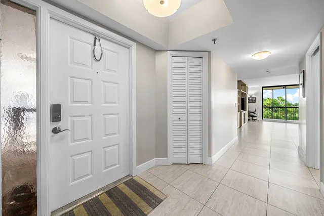 an entryway with wooden floor and cabinet