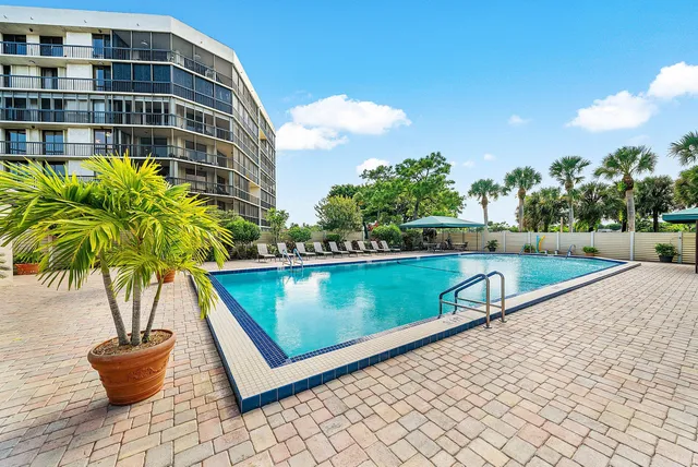 a view of a swimming pool with an outdoor seating