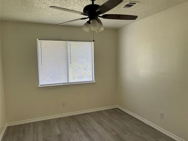 a view of a room with a window and a ceiling fan
