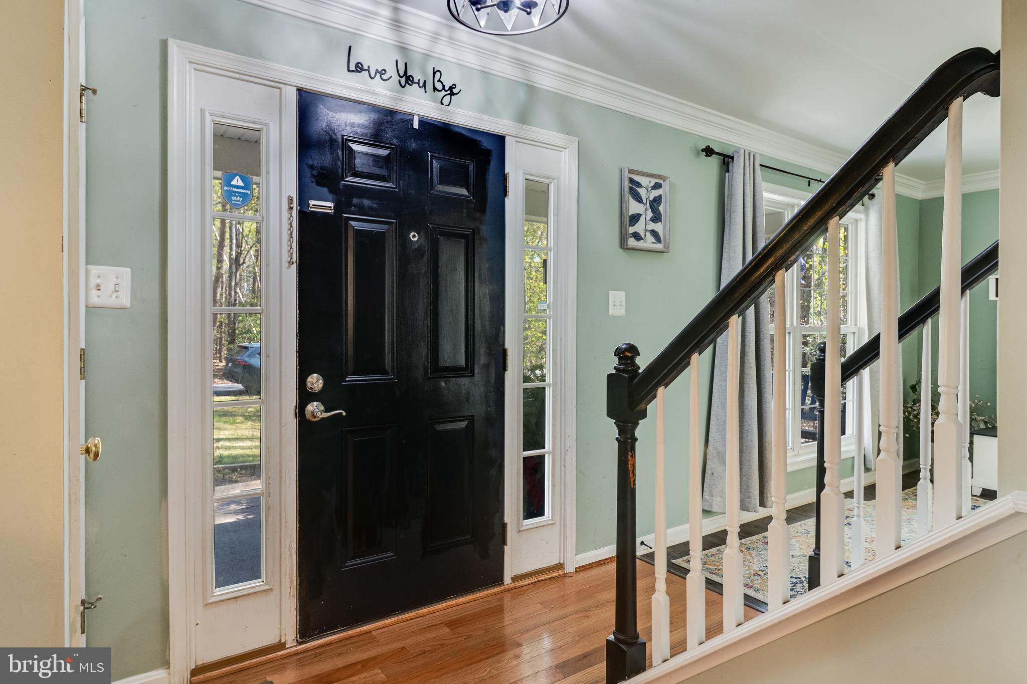 8442 Delegate Drive King George, VA 22485 - Photo 22 of 42 a view of a hallway with wooden floor and staircase