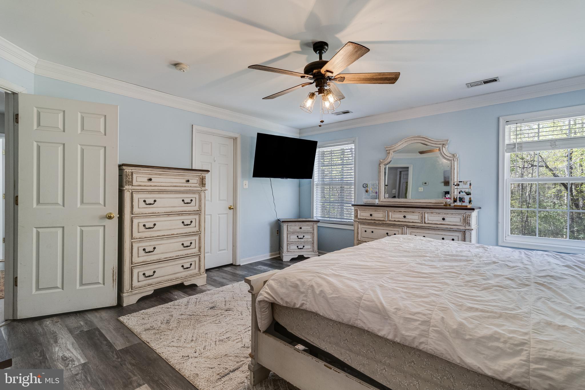 8442 Delegate Drive King George, VA 22485 - Photo 30 of 42 a bedroom with a bed a dresser and a flat screen tv