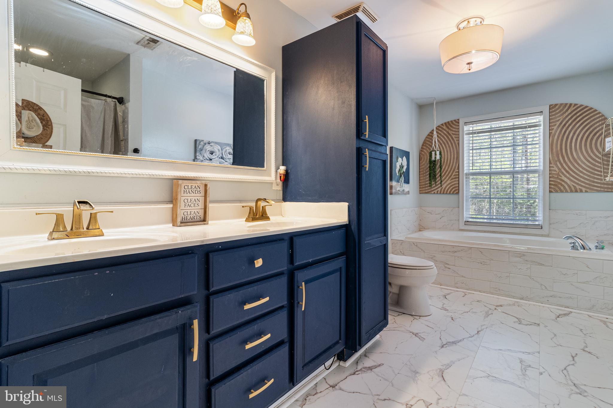 8442 Delegate Drive King George, VA 22485 - Photo 31 of 42 a bathroom with a tub sink and mirror