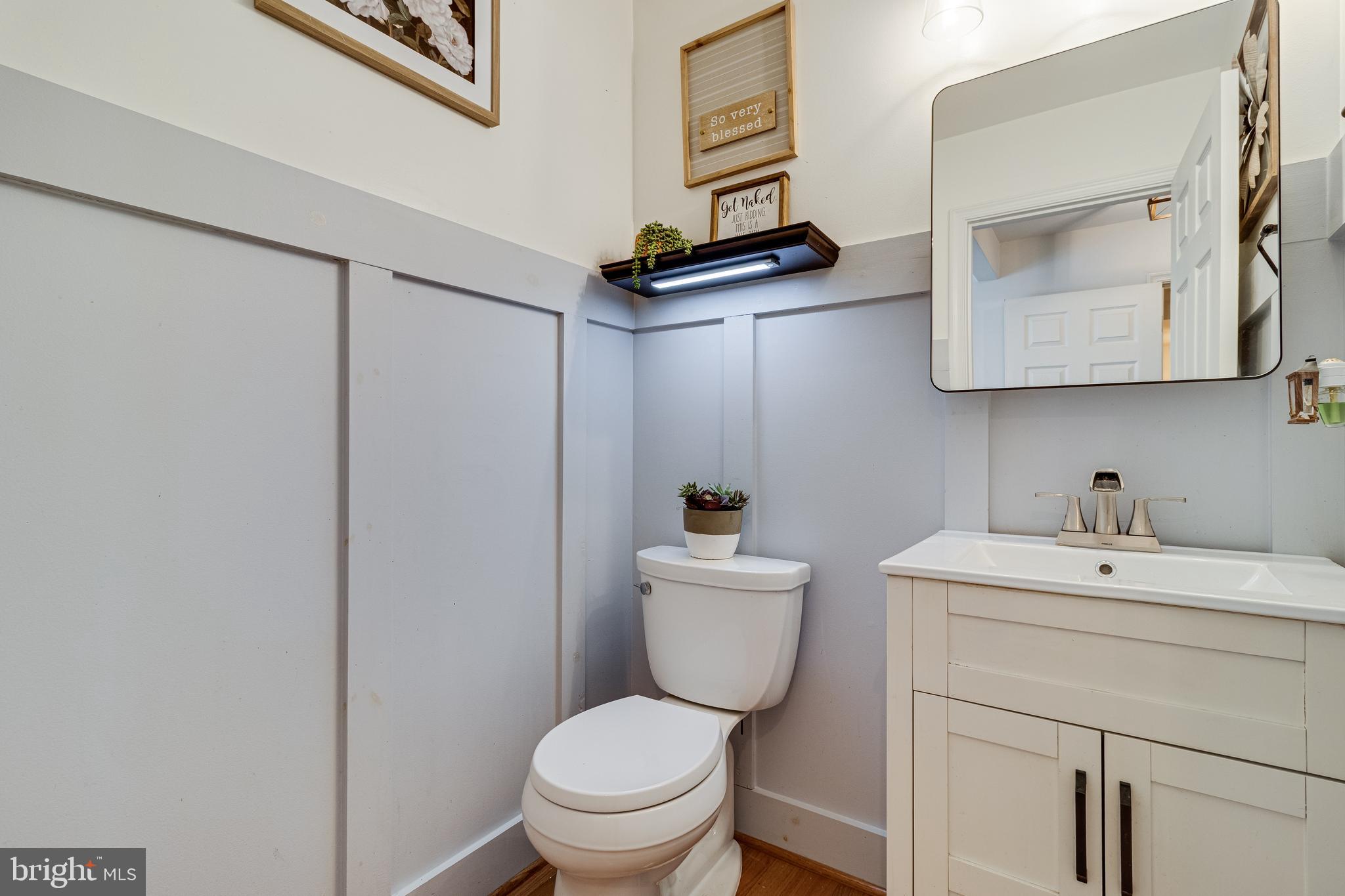 8442 Delegate Drive King George, VA 22485 - Photo 36 of 42 a bathroom with a toilet sink vanity and mirror