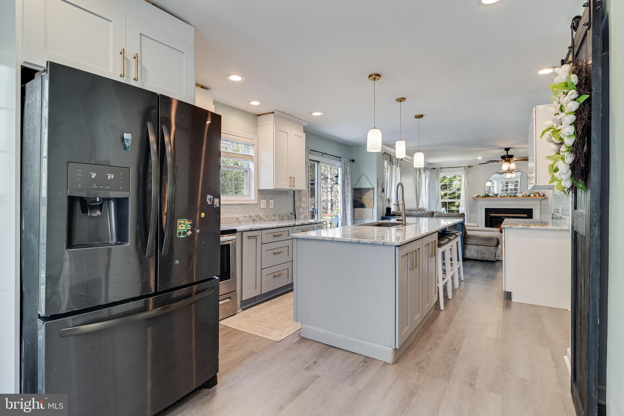 8442 Delegate Drive King George, VA 22485 - Photo 8 of 42 a kitchen with stainless steel appliances kitchen island granite countertop a refrigerator and a sink