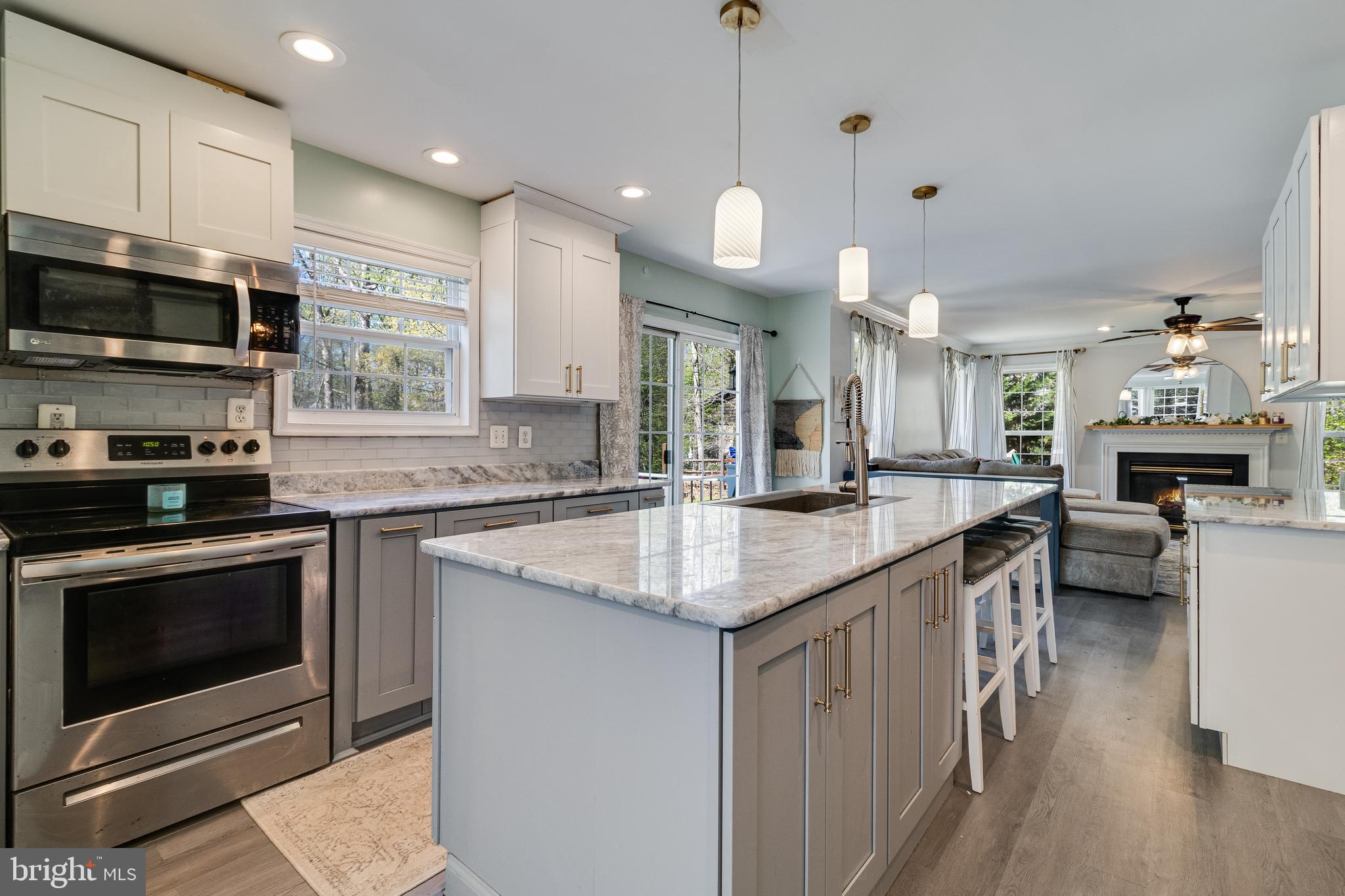 8442 Delegate Drive King George, VA 22485 - Photo 9 of 42 a kitchen with stainless steel appliances granite countertop a stove a sink and a microwave