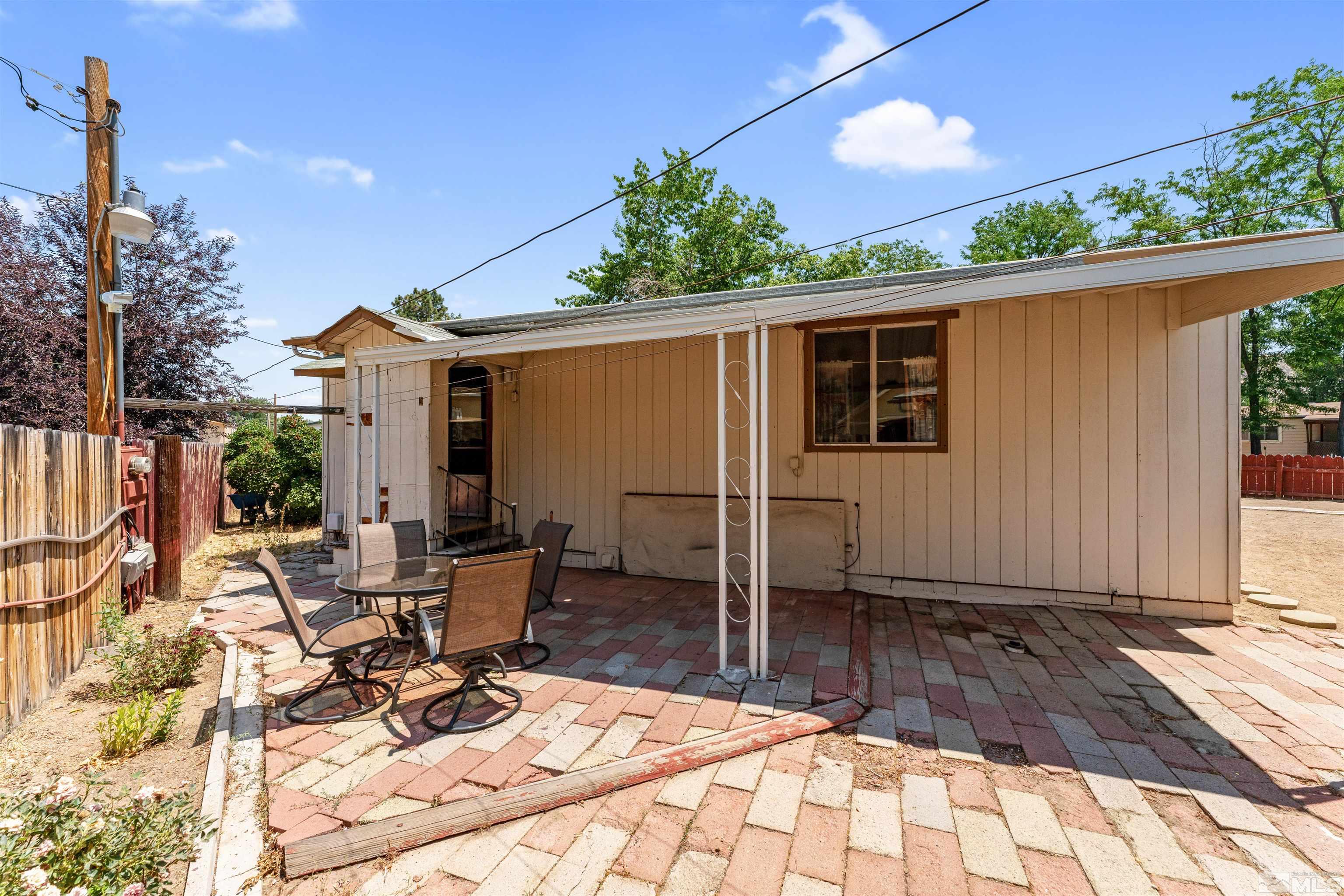 467 Magnolia Way Reno, NV 89506 - Photo 28 of 40 a view of a patio with table and chairs with wooden floor and fence