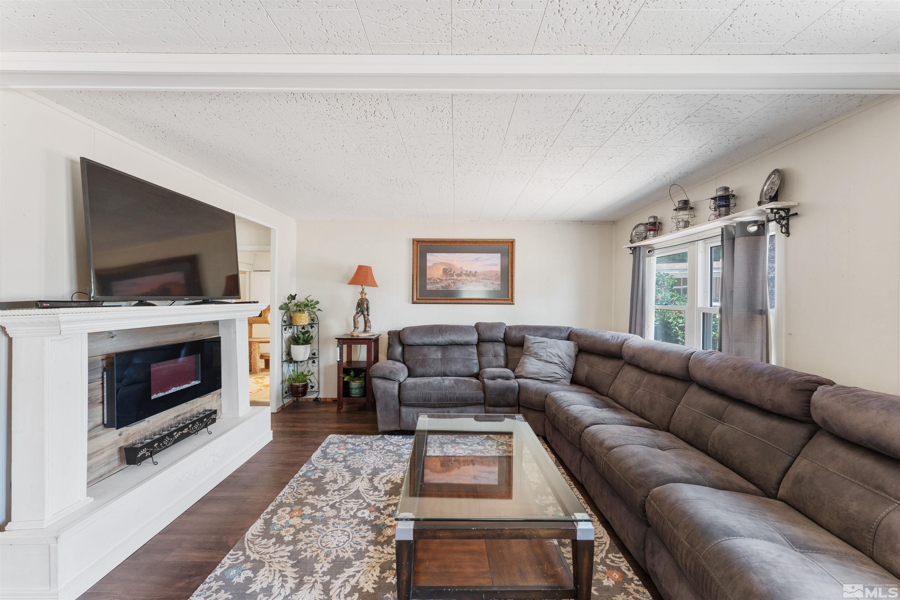 467 Magnolia Way Reno, NV 89506 - Photo 4 of 40 a living room with furniture a flat screen tv and a fireplace