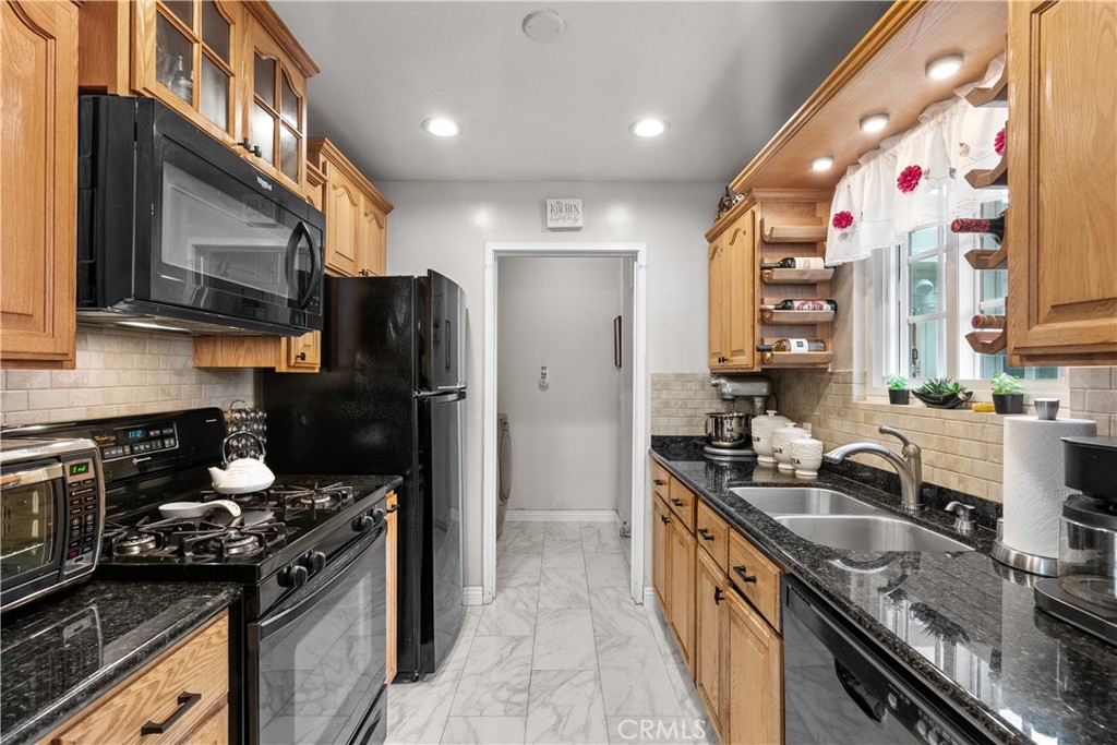 1902 North Screenland Drive Burbank, CA 91505 - Photo 16 of 25 a kitchen with granite countertop stainless steel appliances a sink stove top oven and refrigerator