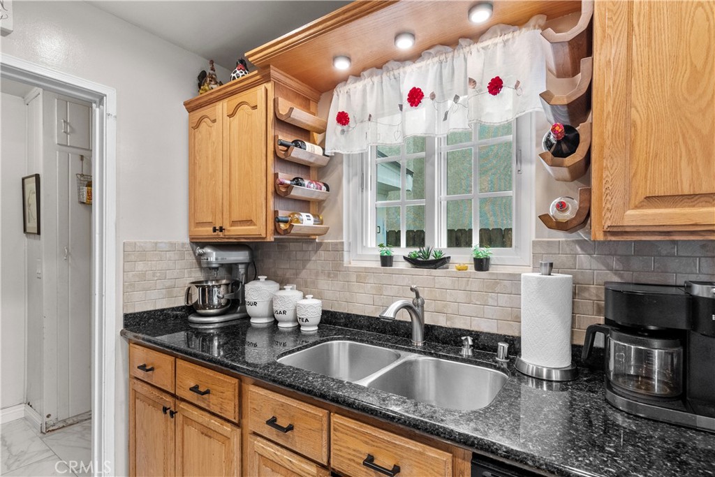 1902 North Screenland Drive Burbank, CA 91505 - Photo 17 of 25 a kitchen with granite countertop a sink stove and cabinets