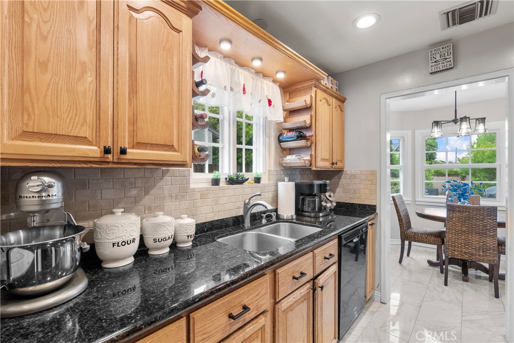 1902 North Screenland Drive Burbank, CA 91505 - Photo 18 of 25 a kitchen with stainless steel appliances granite countertop a sink stove and cabinets