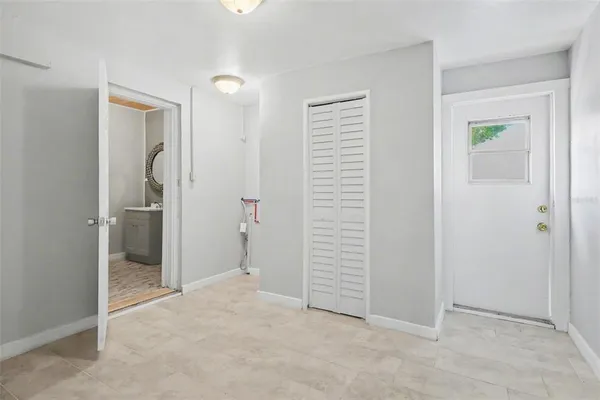 an empty room with windows and closet