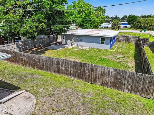 a view of a house with a yard and furniture