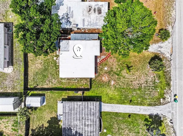 a view of a brick wall with a tree in the background