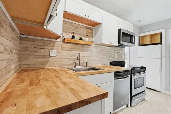 a kitchen with stainless steel appliances granite countertop a sink and a stove