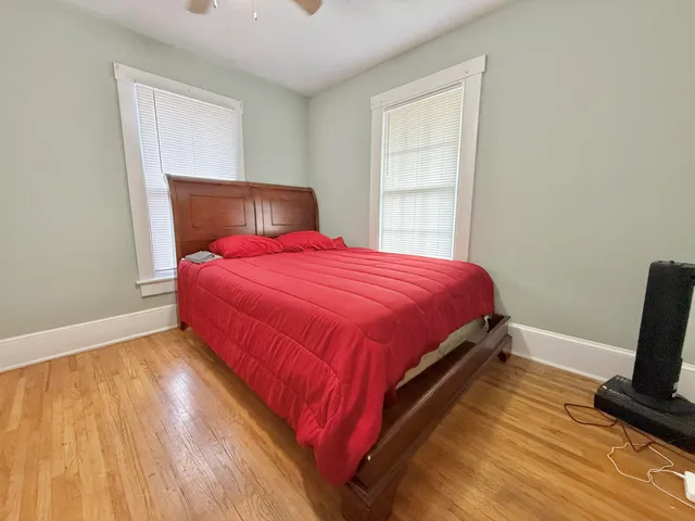 a bedroom with bed and window