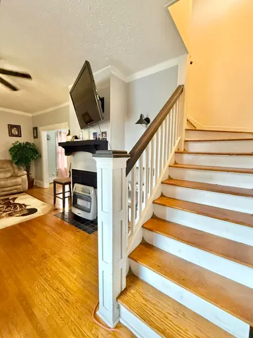 a bedroom with a bed window and a ceiling fan