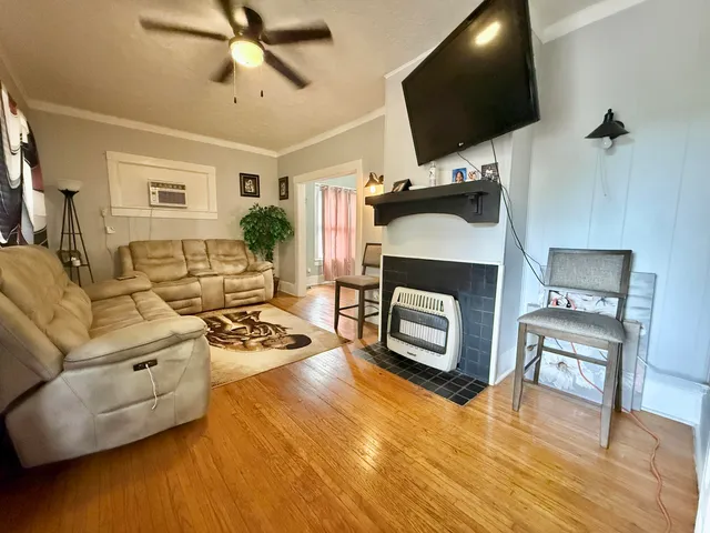 a bedroom with furniture and a wooden floor