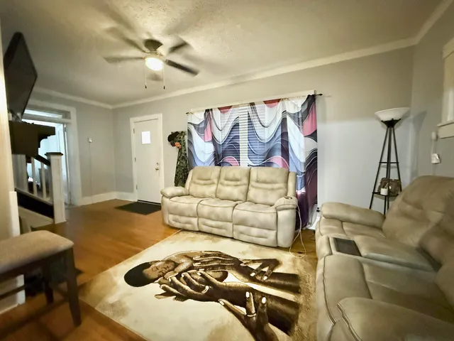 a bedroom with furniture and a wooden floor