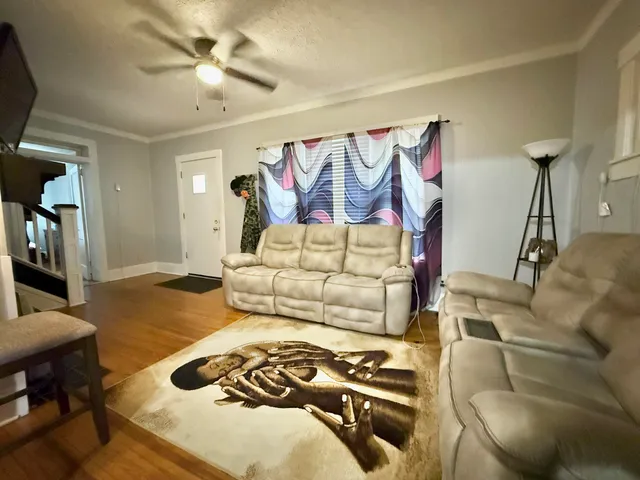a view of a workspace with furniture and chandelier