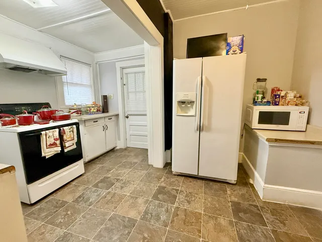 a kitchen with stainless steel appliances granite countertop a stove top oven and cabinets