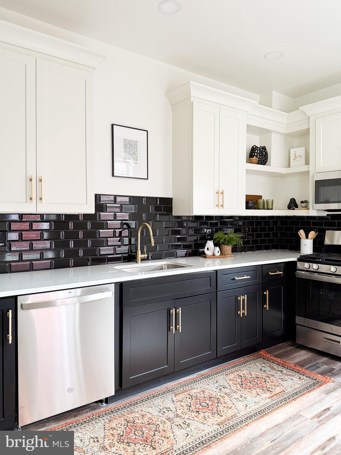 328 Walnut Street Columbia, PA 17512 - Photo 11 of 28 a kitchen with stainless steel appliances granite countertop a stove a sink and white cabinets