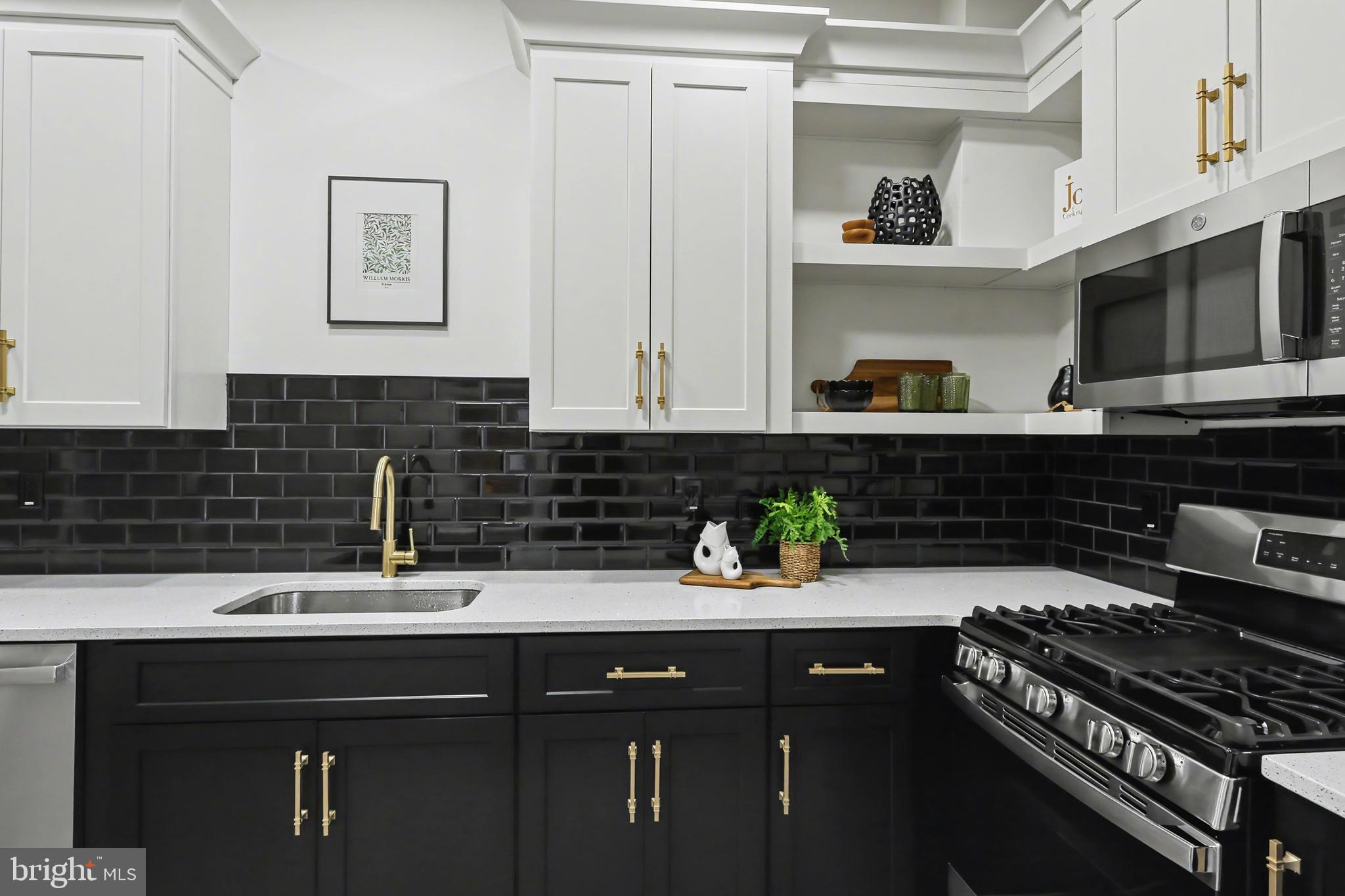 328 Walnut Street Columbia, PA 17512 - Photo 13 of 28 a kitchen with stainless steel appliances a sink a stove and cabinets