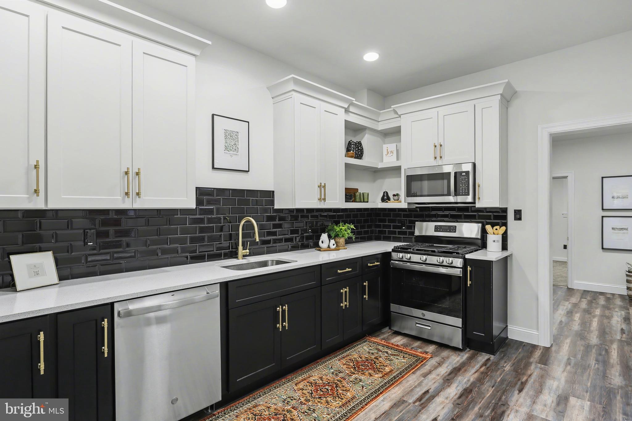 328 Walnut Street Columbia, PA 17512 - Photo 14 of 28 a kitchen with stainless steel appliances granite countertop a stove a sink and white cabinets