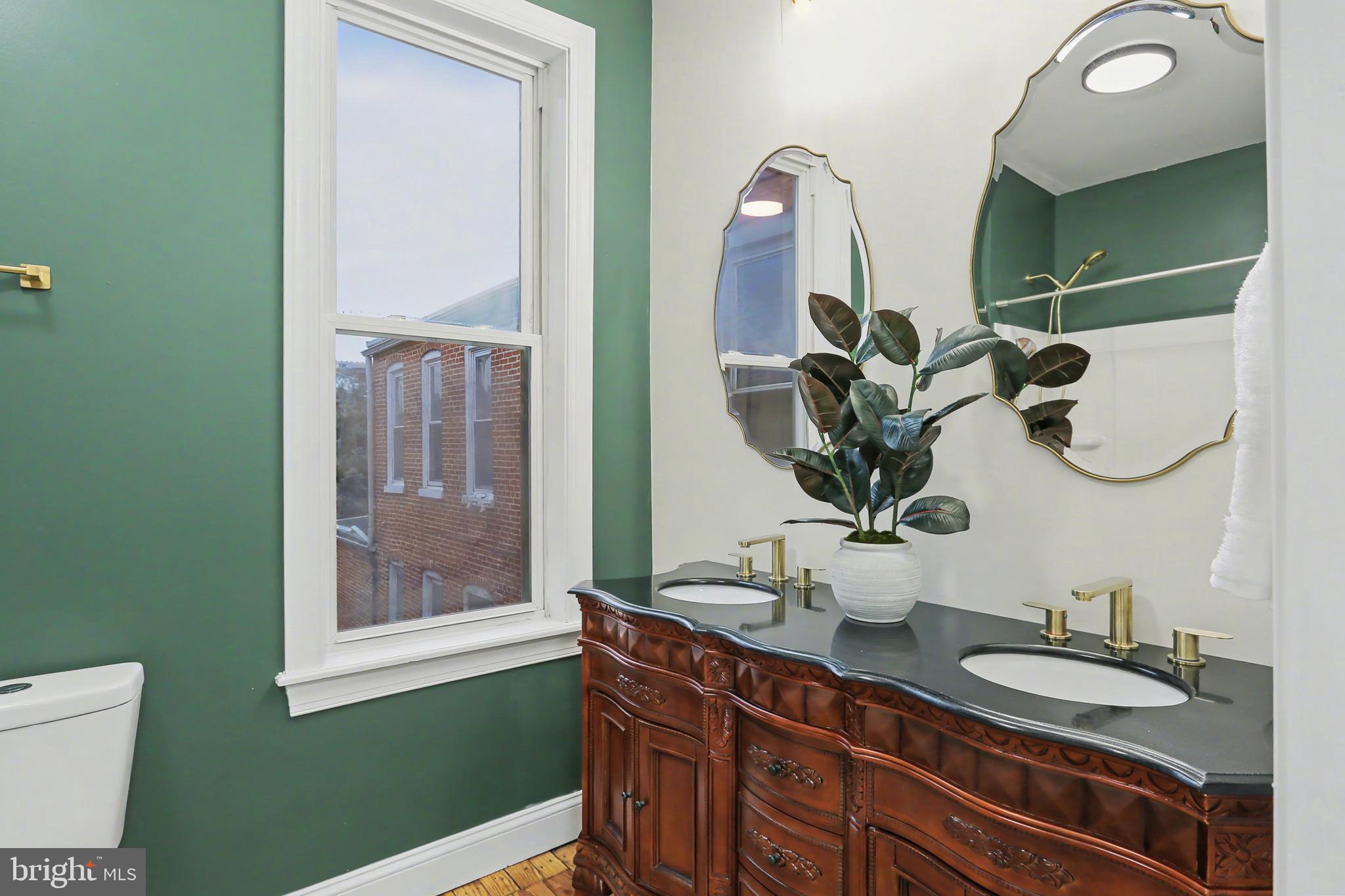 328 Walnut Street Columbia, PA 17512 - Photo 17 of 28 a bathroom with a double vanity sink and a mirror