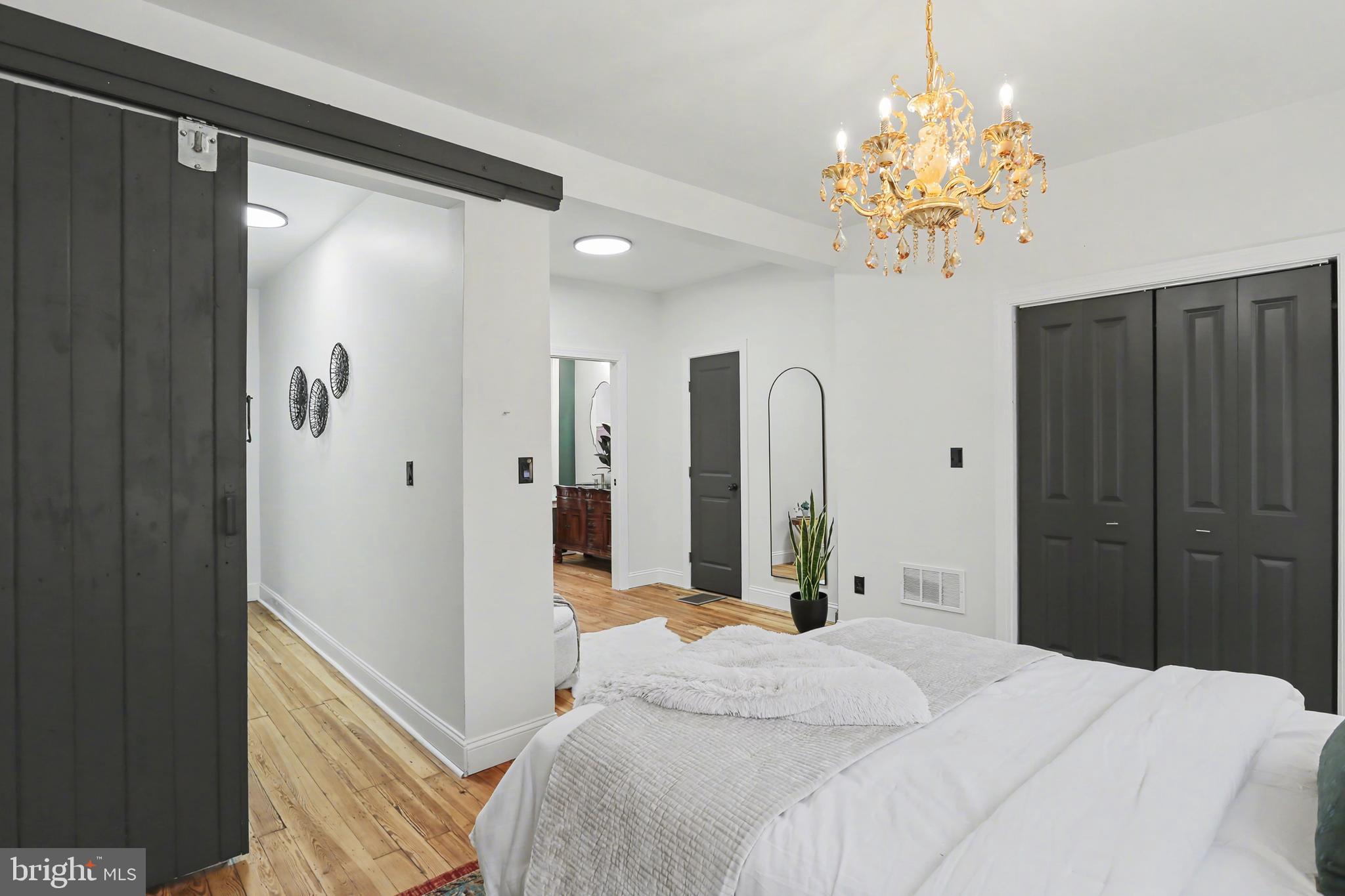 328 Walnut Street Columbia, PA 17512 - Photo 20 of 28 a bedroom with a chandelier and a dresser