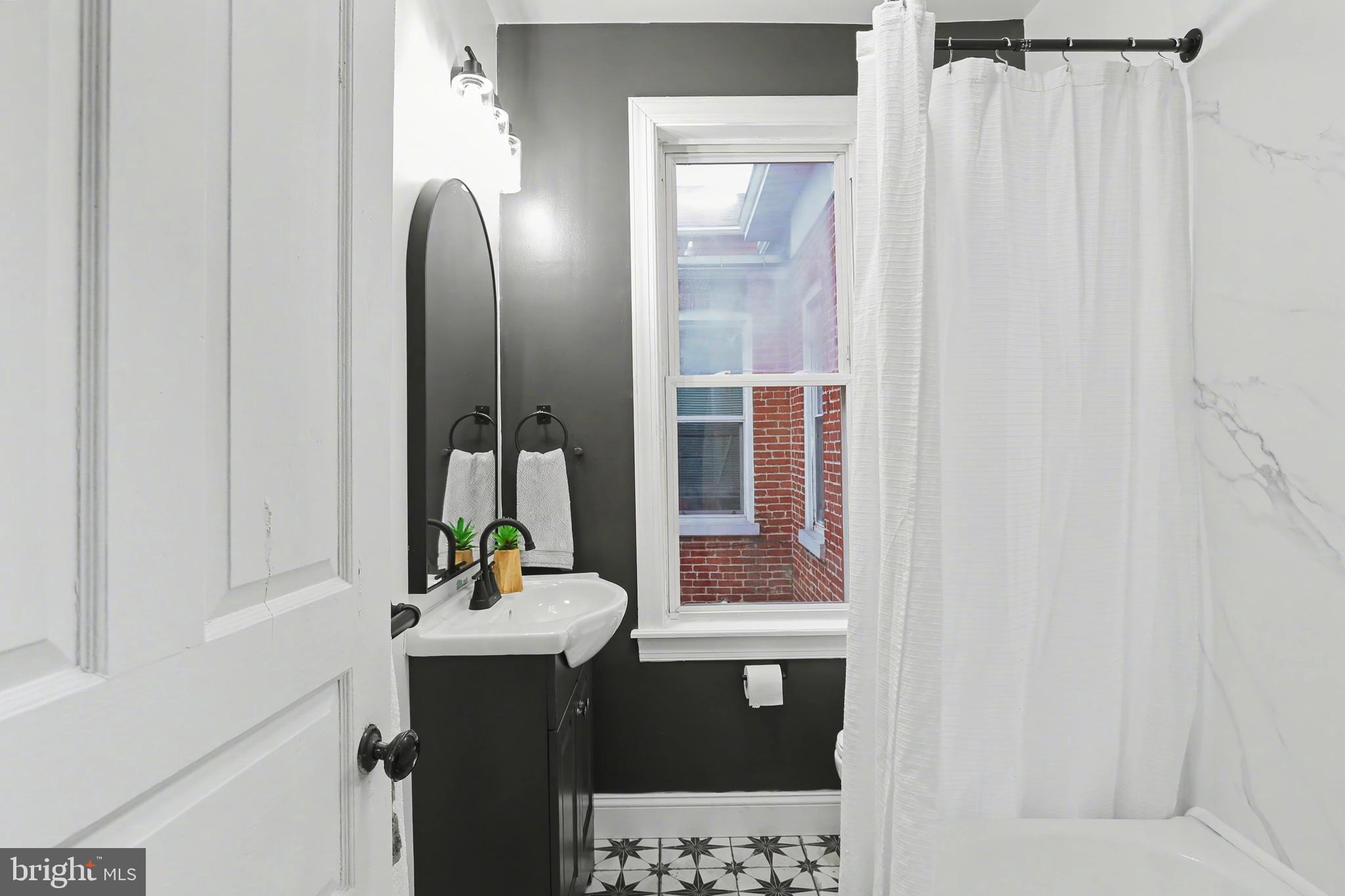 328 Walnut Street Columbia, PA 17512 - Photo 24 of 28 a bathroom with a sink vanity and a mirror