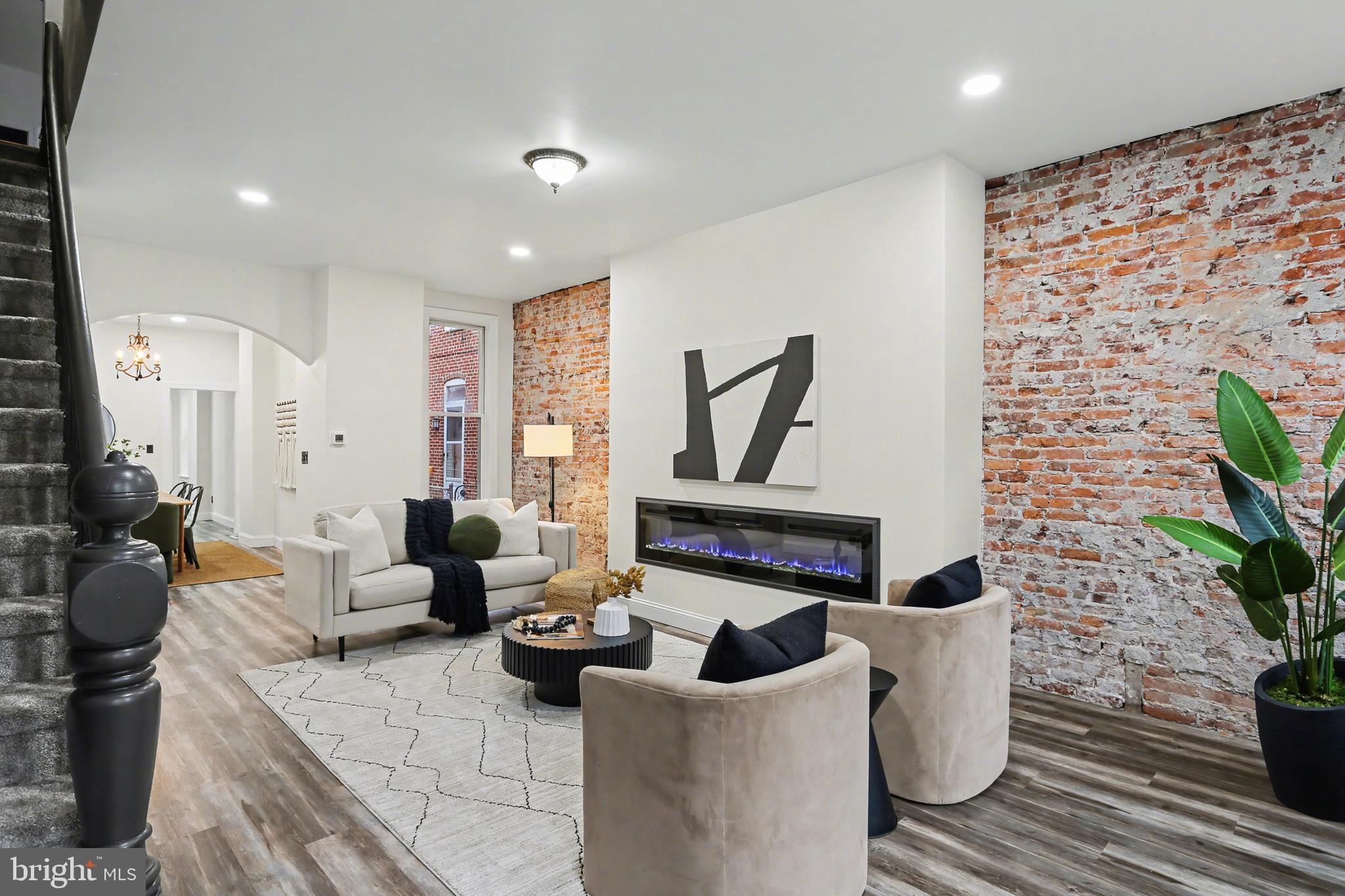328 Walnut Street Columbia, PA 17512 - Photo 4 of 28 a living room with furniture a rug and a potted plant