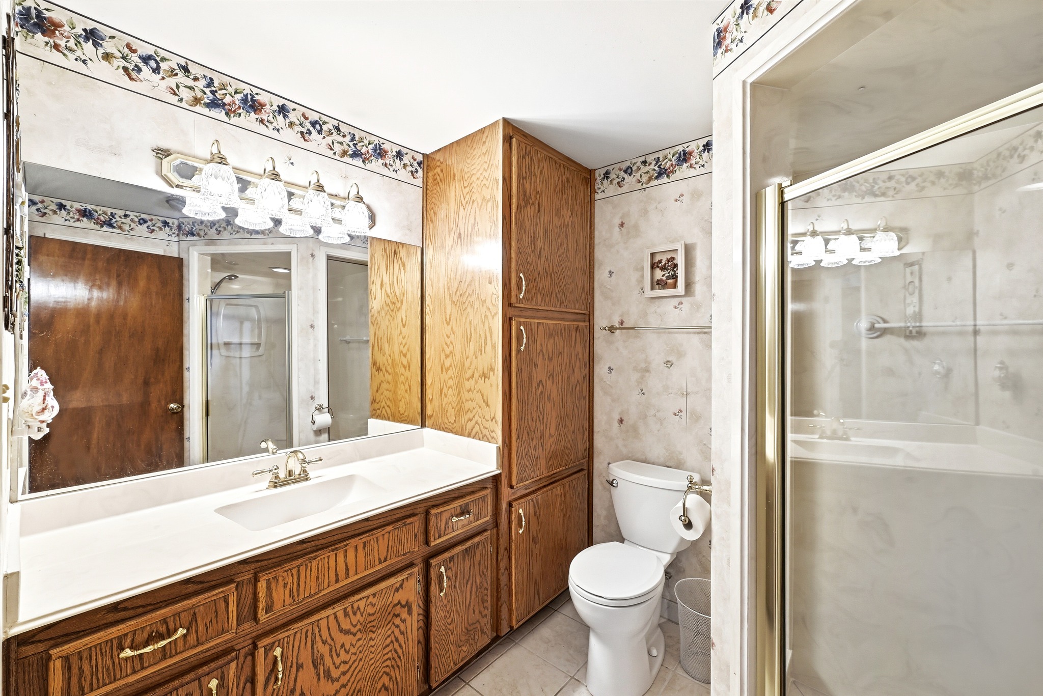 4619 Banister Lane Austin, TX 78745 - Photo 19 of 34 Bathroom featuring a stall shower, vanity, and light tile patterned floors
