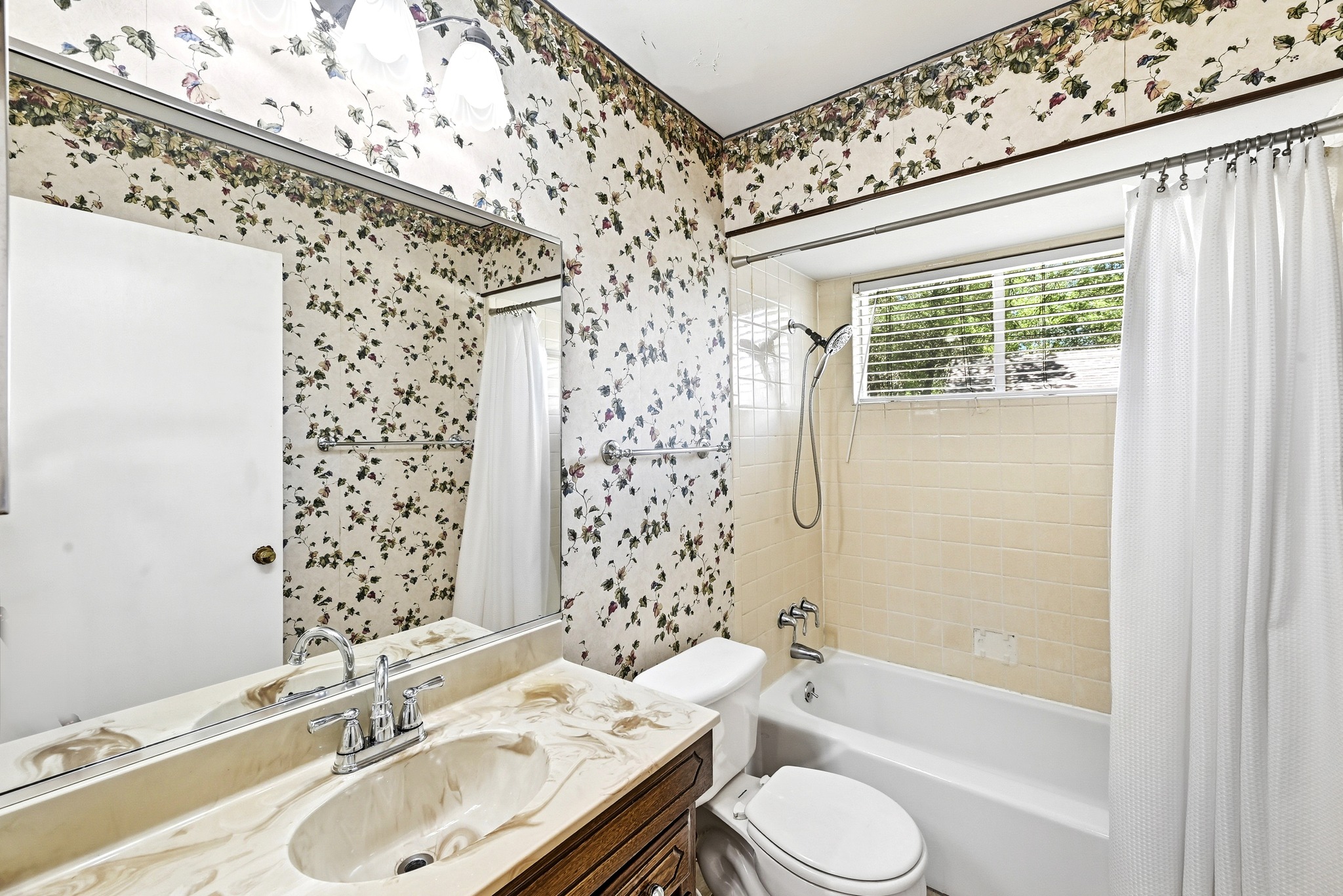 4619 Banister Lane Austin, TX 78745 - Photo 23 of 34 Full bathroom featuring vanity, shower / tub combo, and wallpapered walls