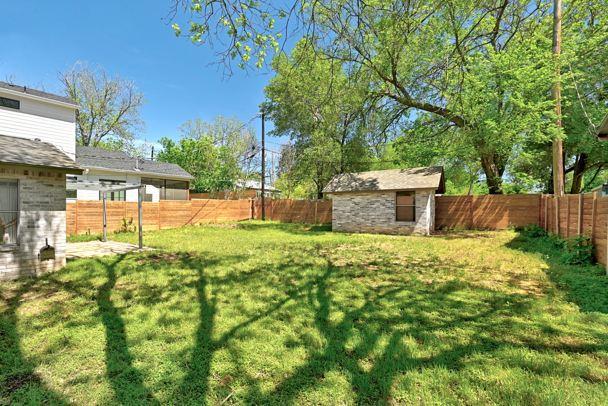4619 Banister Lane Austin, TX 78745 - Photo 25 of 34 Fenced backyard with a storage shed and a patio area