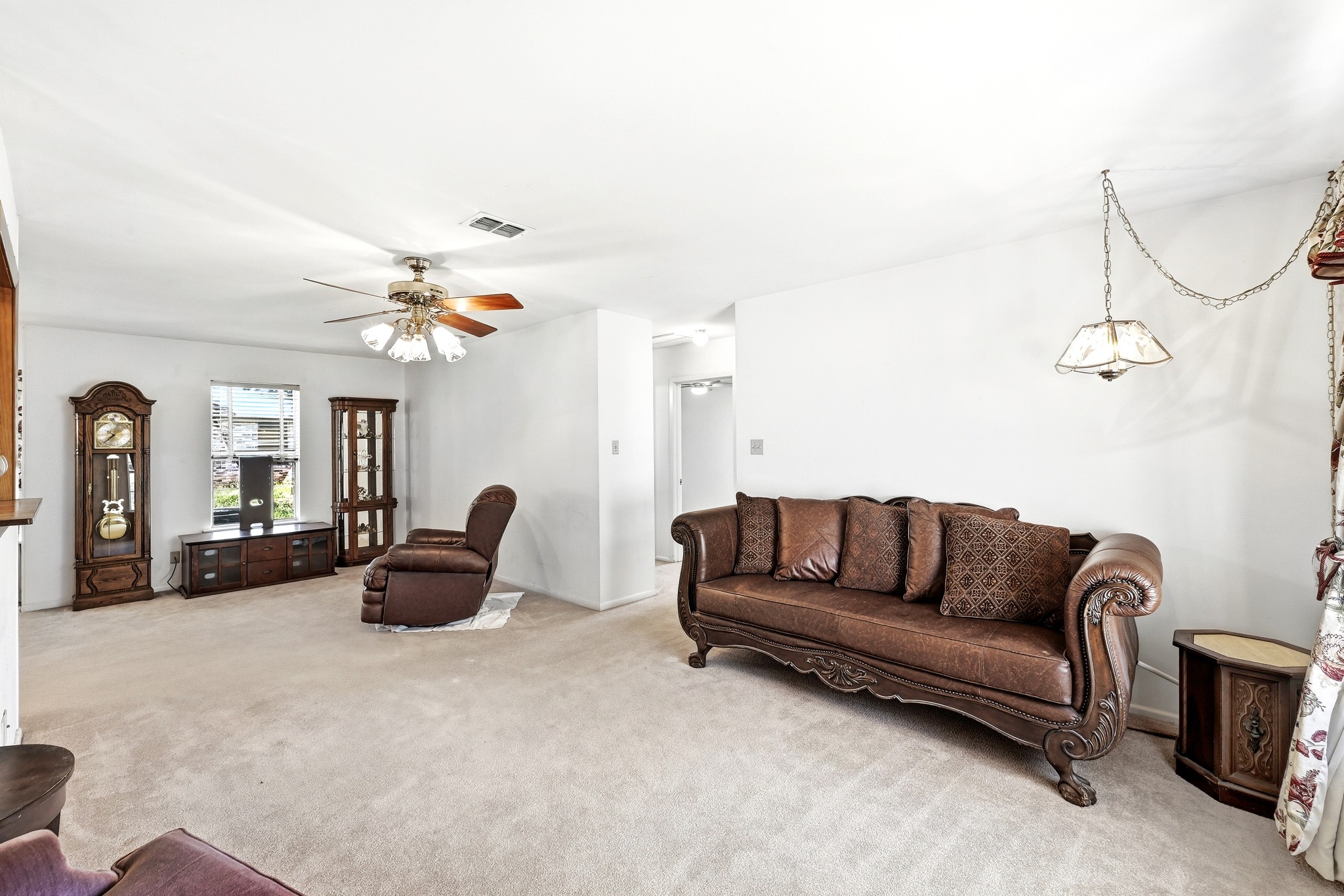 4619 Banister Lane Austin, TX 78745 - Photo 5 of 34 Living area featuring light carpet and a ceiling fan