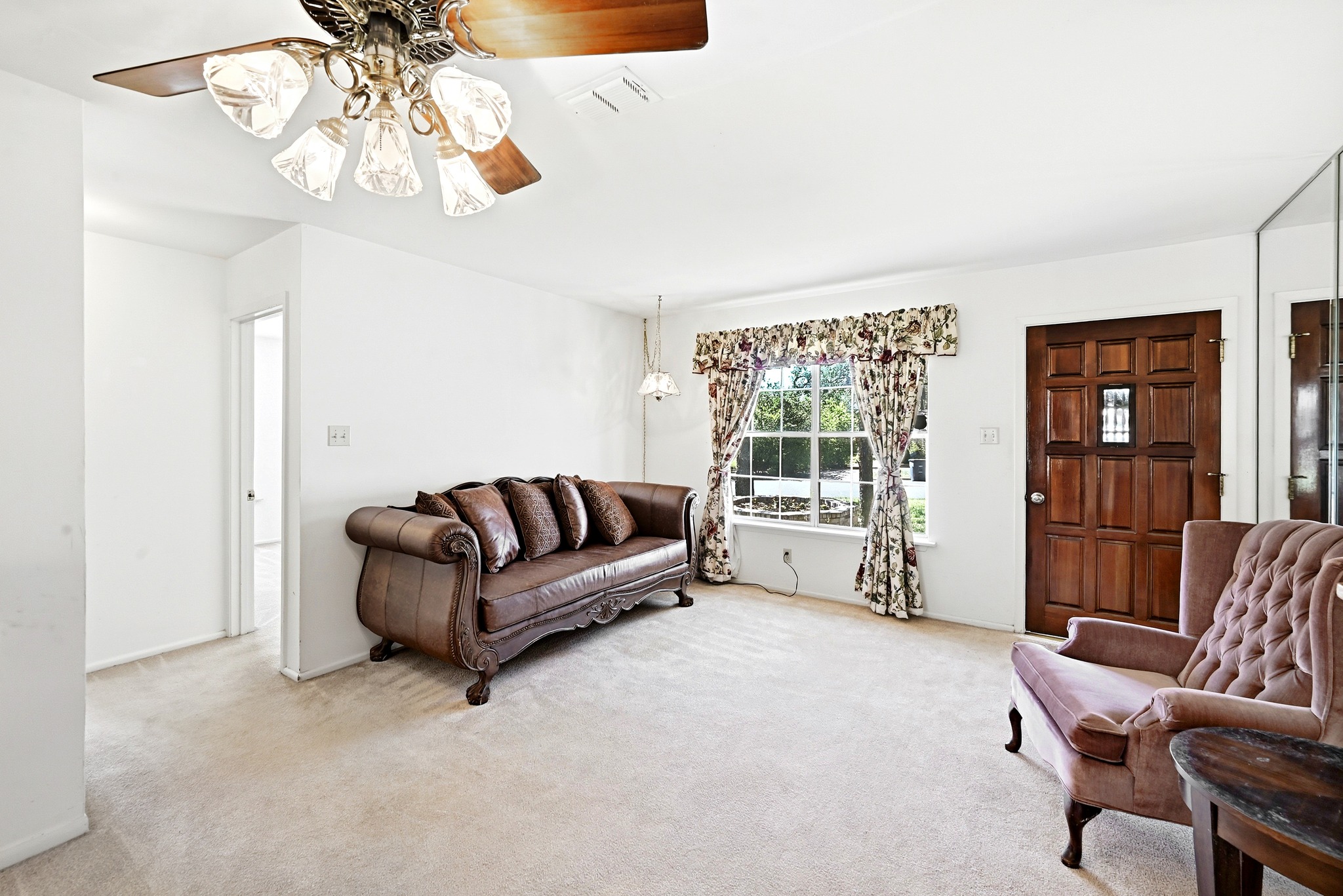 4619 Banister Lane Austin, TX 78745 - Photo 7 of 34 Living area featuring light carpet and ceiling fan