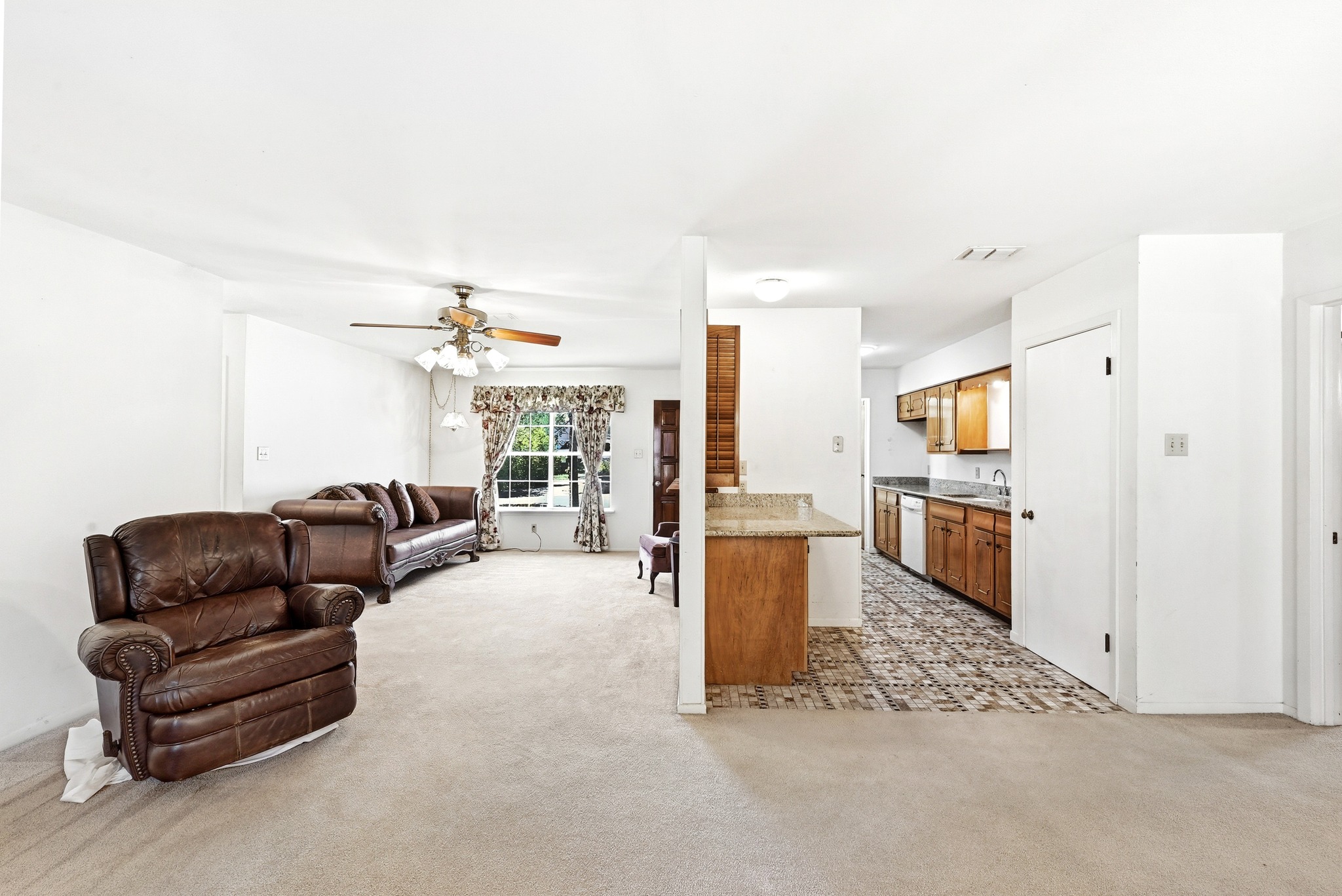 4619 Banister Lane Austin, TX 78745 - Photo 8 of 34 Living area with ceiling fan and light carpet