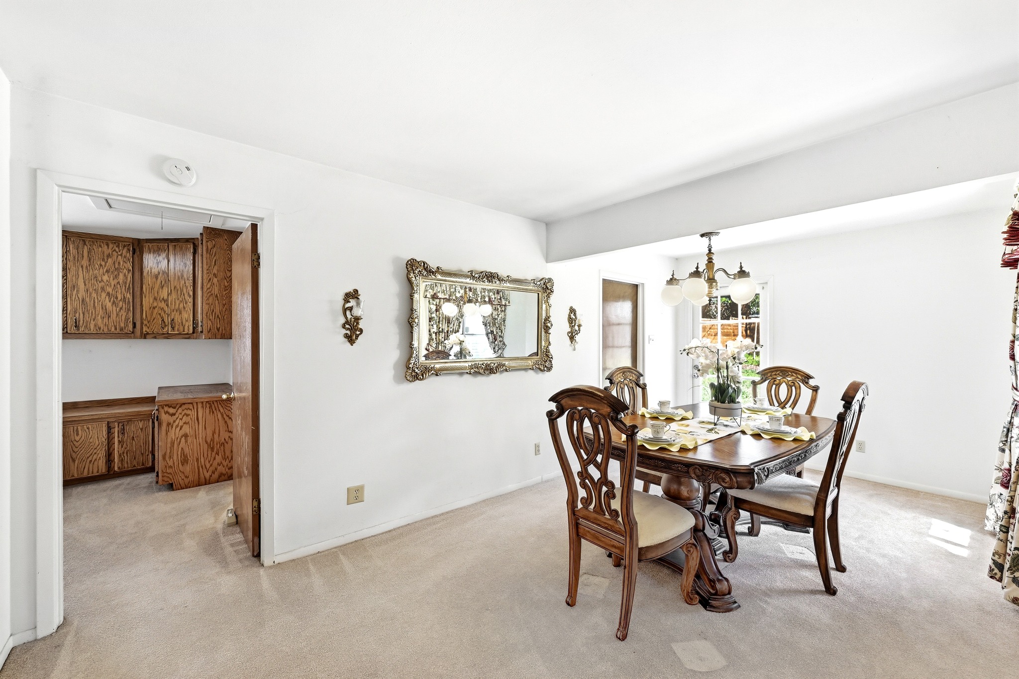 4619 Banister Lane Austin, TX 78745 - Photo 9 of 34 Dining space featuring light carpet and a chandelier